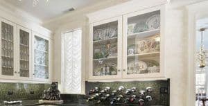 Elegant kitchen featuring custom glass cabinets