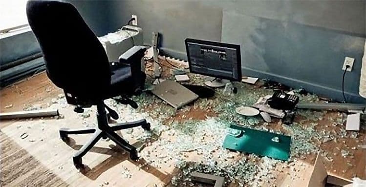 Office space with shattered glass scattered on the floor