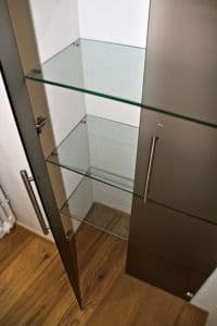 Custom glass shelves within a modern cabinet