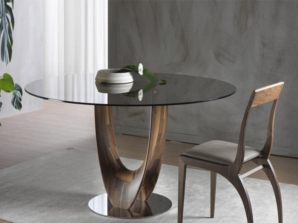 Round glass table top with a sleek black tempered glass surface, set on a stylish wooden base, showcasing custom glass design in a modern interior.