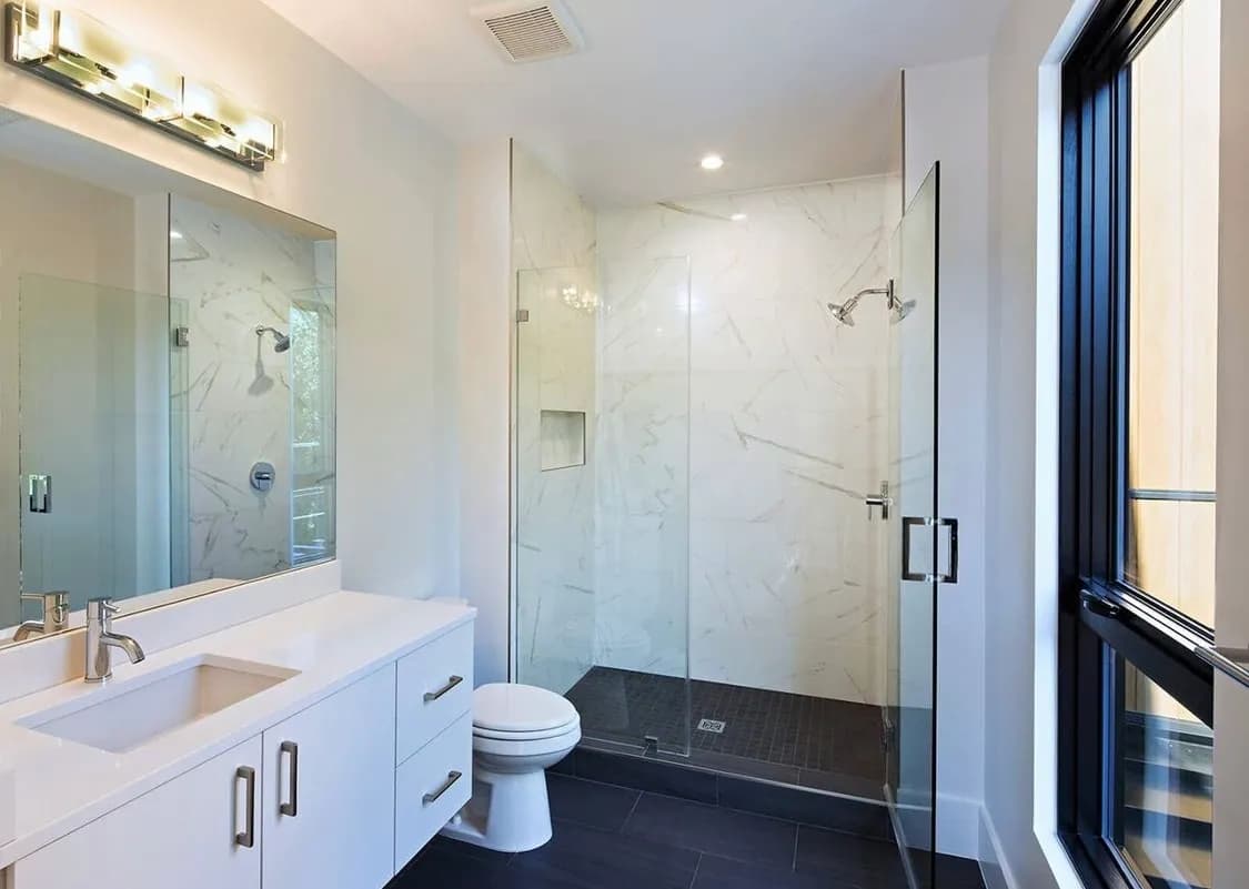 Modern bathroom featuring custom shower doors