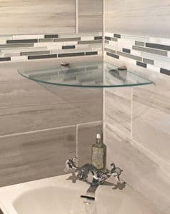 Custom tempered glass corner shelf in a modern bathroom