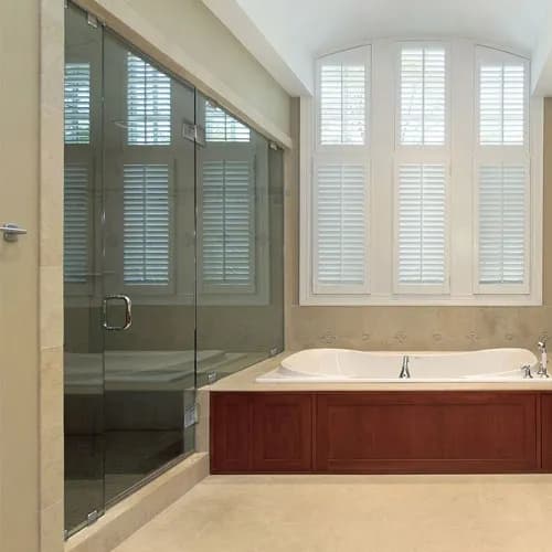 Modern bathroom featuring custom glass shower doors