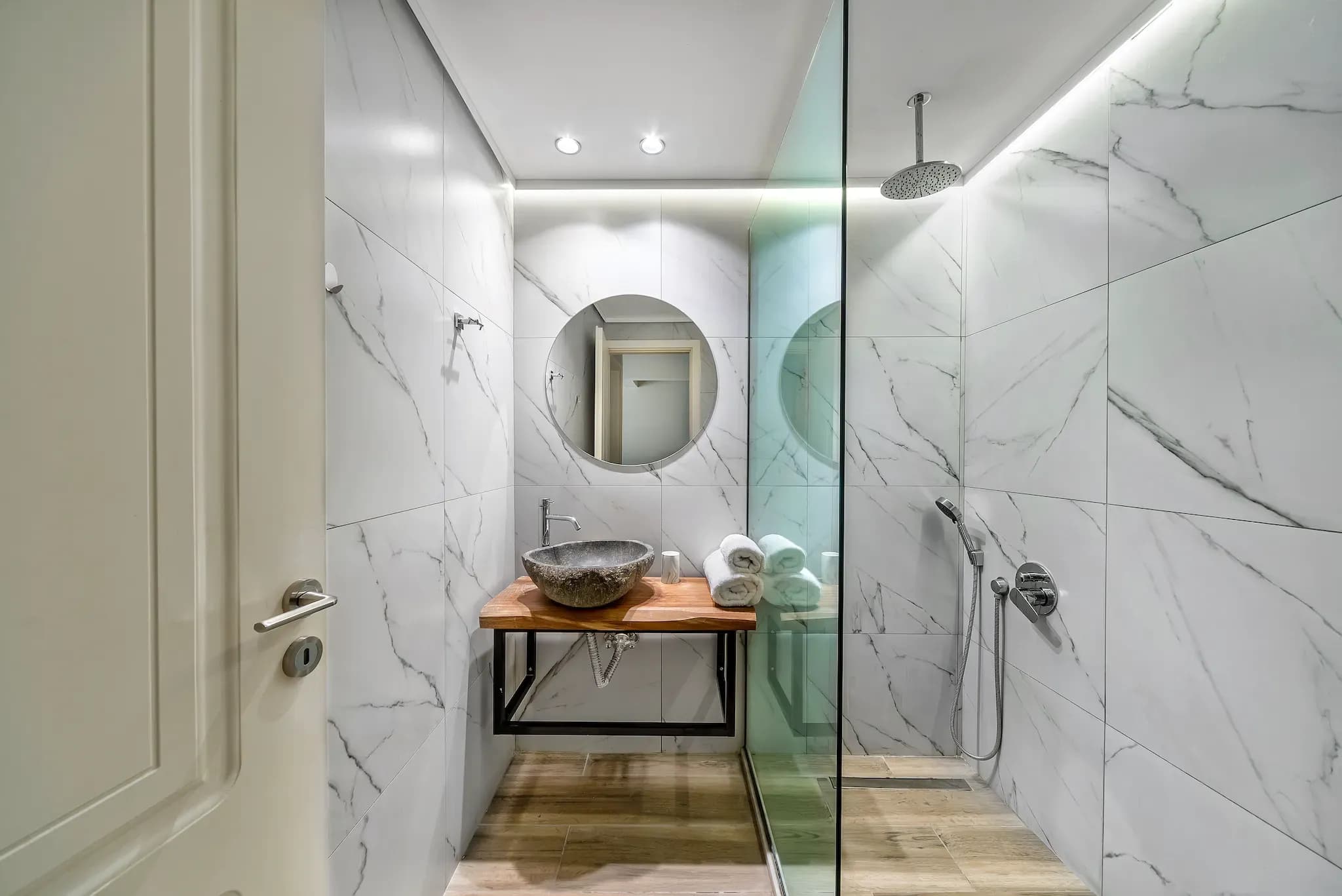 Modern bathroom featuring a custom glass shower door
