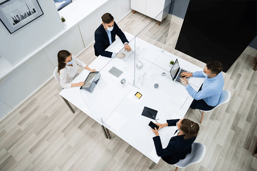 Professional meeting with custom glass barriers on a table