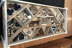 custom glass table top showcasing decorative objects and storage compartments