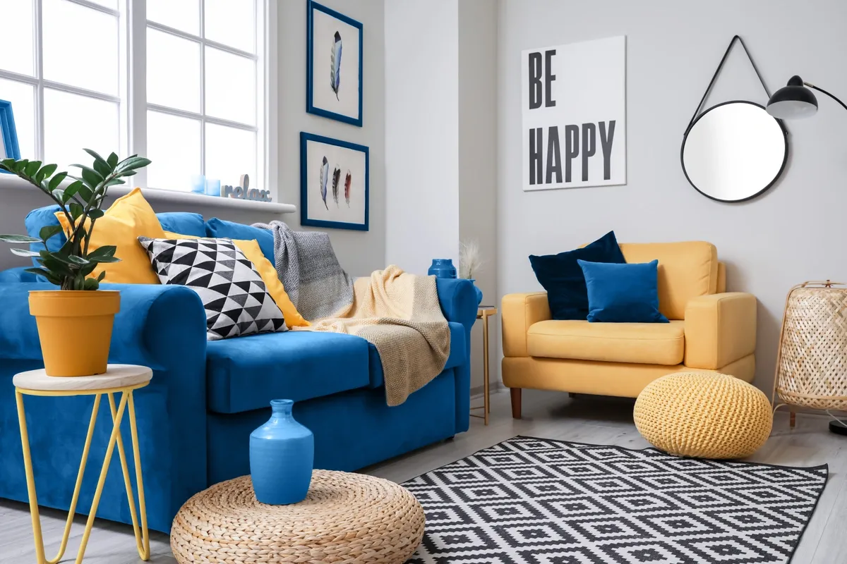 Example of mirror use, round mirror hung in a yellow and blue accented living room 