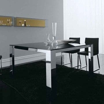 Contemporary dining area featuring a sleek black glass table with chrome legs