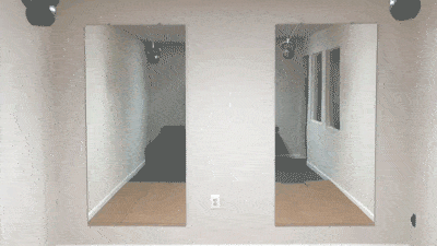 Two large custom mirrors with beveled glass edges mounted on a plain wall