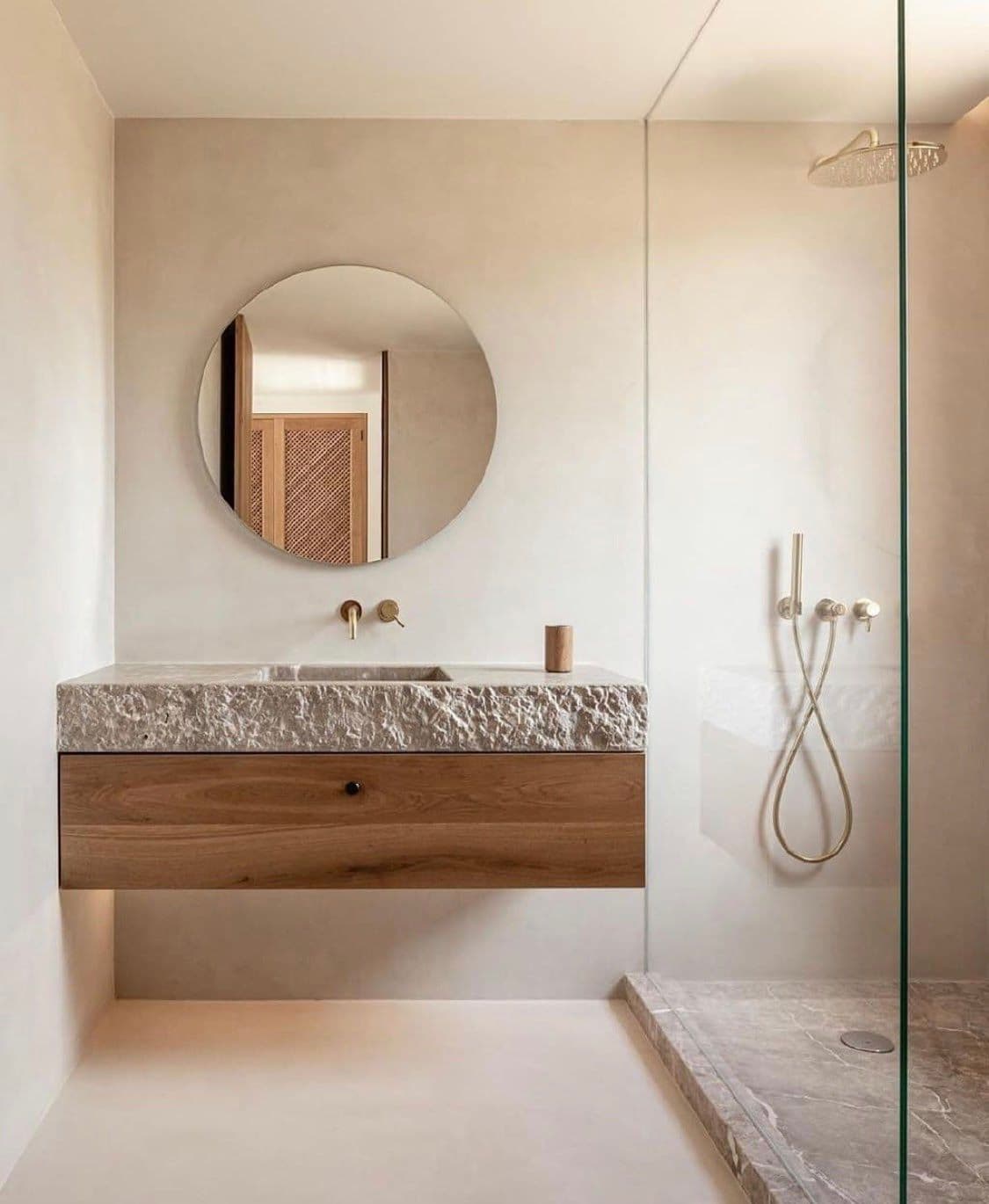 Modern bathroom featuring a round mirror