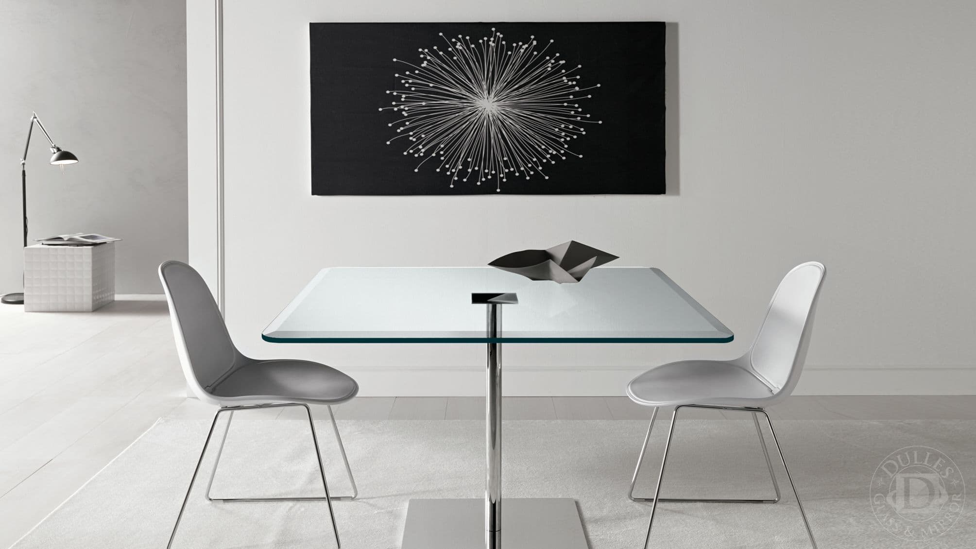 Modern glass dining table with tempered glass top, complemented by sleek chairs and decorative elements, showcasing custom glass design.