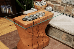Custom glass table top on a wooden base with decorative stones