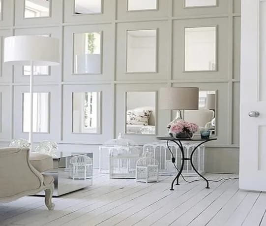 Elegant living space featuring a wall of framed mirrors