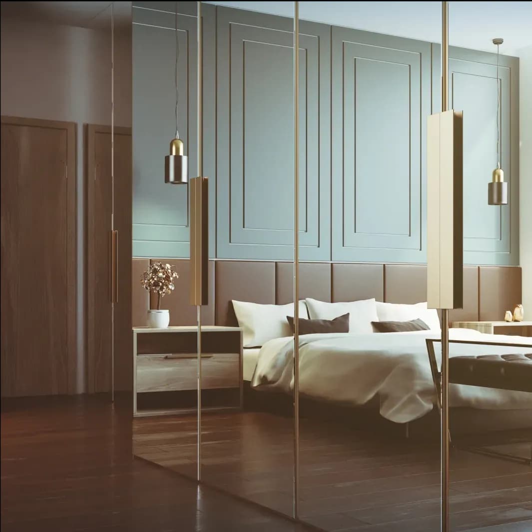 Modern bedroom featuring custom glass mirrors and stylish decor, highlighting elements of tempered glass and beveled glass edges in an elegant design.