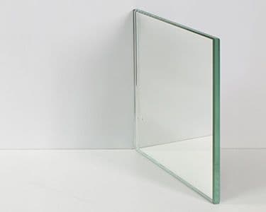 Custom glass panel with a beveled edge, suitable for use in shower doors, table tops, and mirrors; made from tempered glass for durability.
