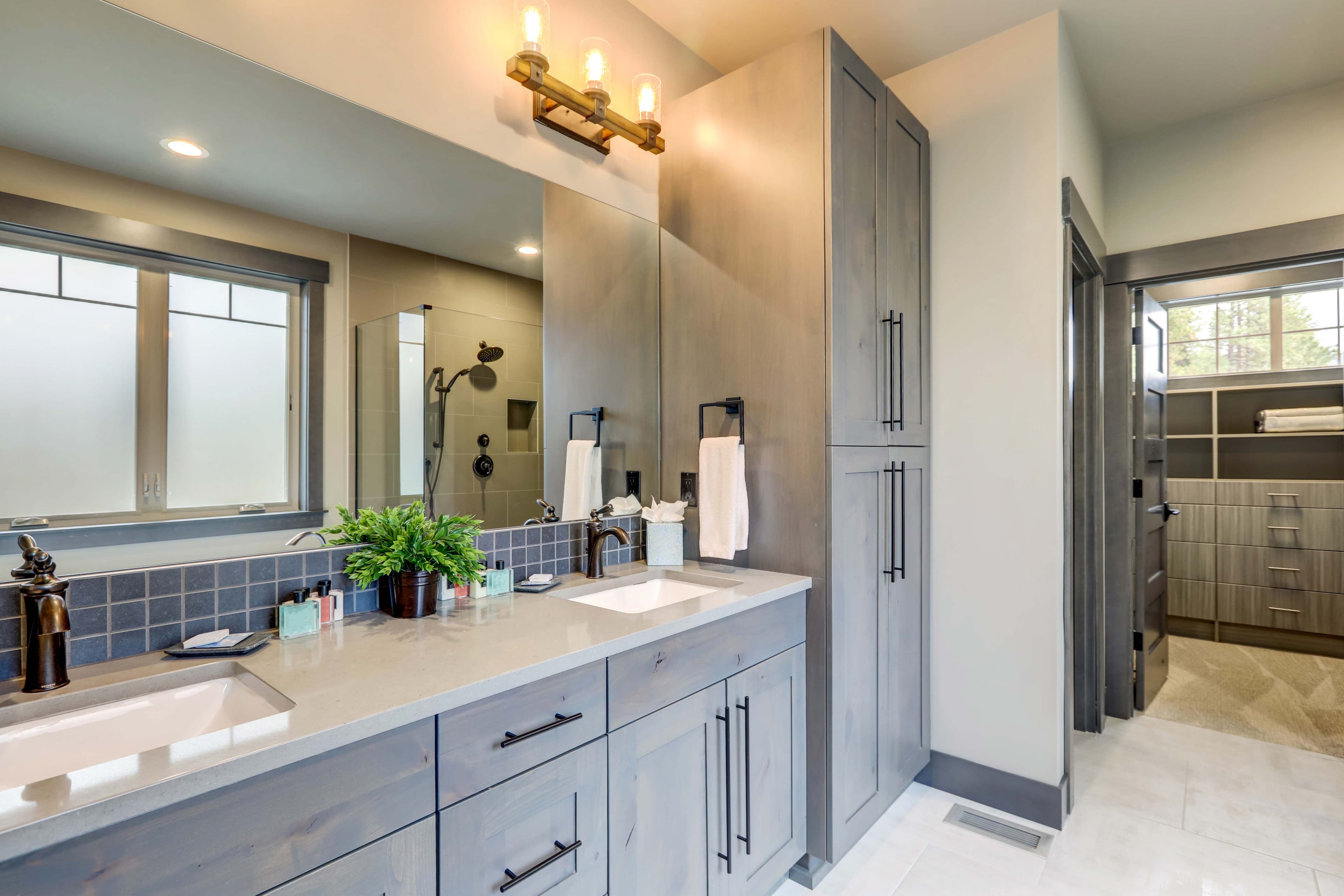 Modern bathroom featuring custom glass mirrors, stylish shower doors, and a sleek countertop ideal for table tops, showcasing tempered glass and beveled glass edges.