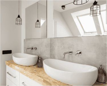 Modern bathroom featuring custom mirrors above dual vessel sinks with a natural wood countertop, showcasing elegant design elements for shower doors and tempered glass applications.