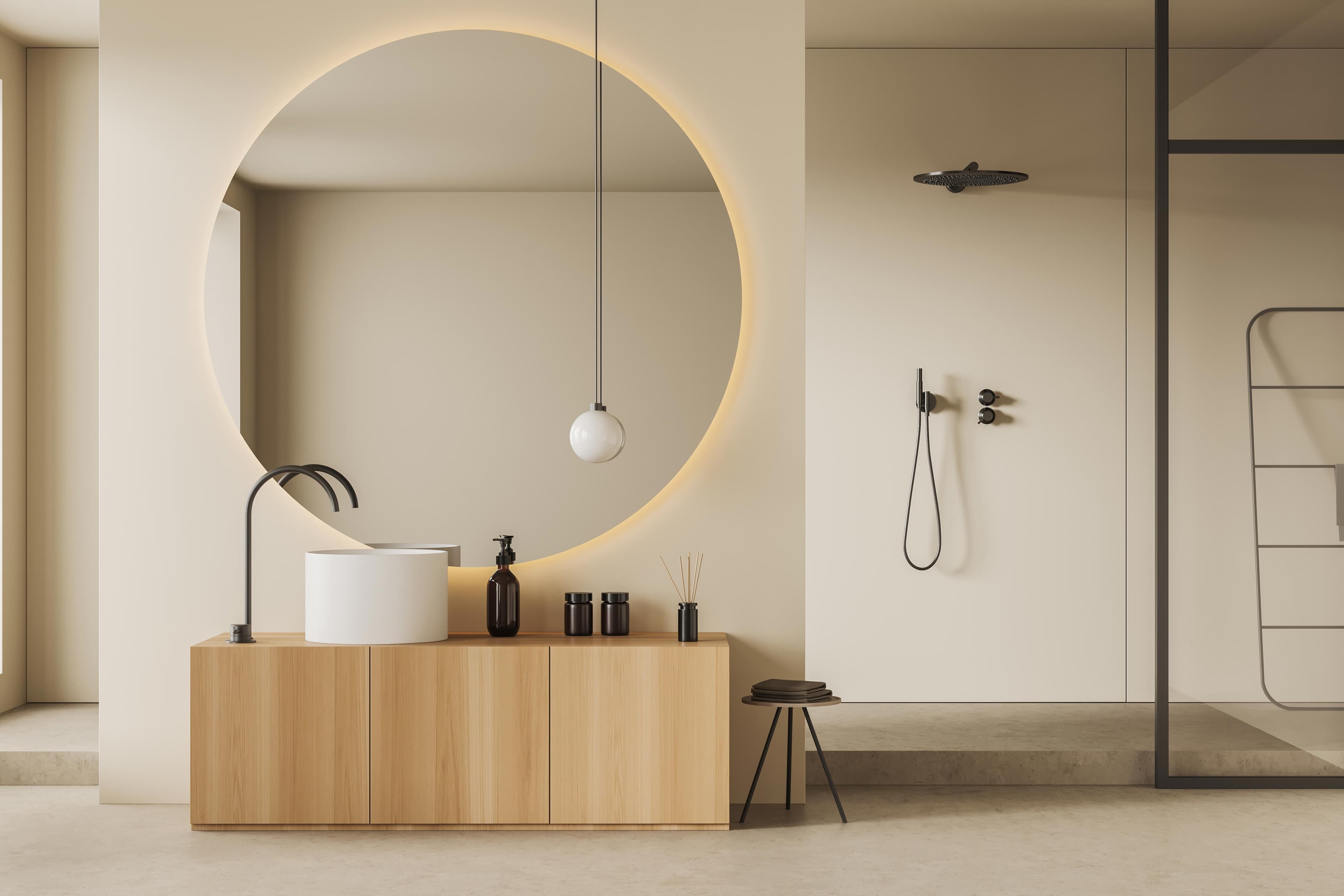 Modern bathroom featuring a large circular mirror, wooden vanity with sink, stylish lighting, and a glass shower door, highlighting custom glass and tempered glass design elements.