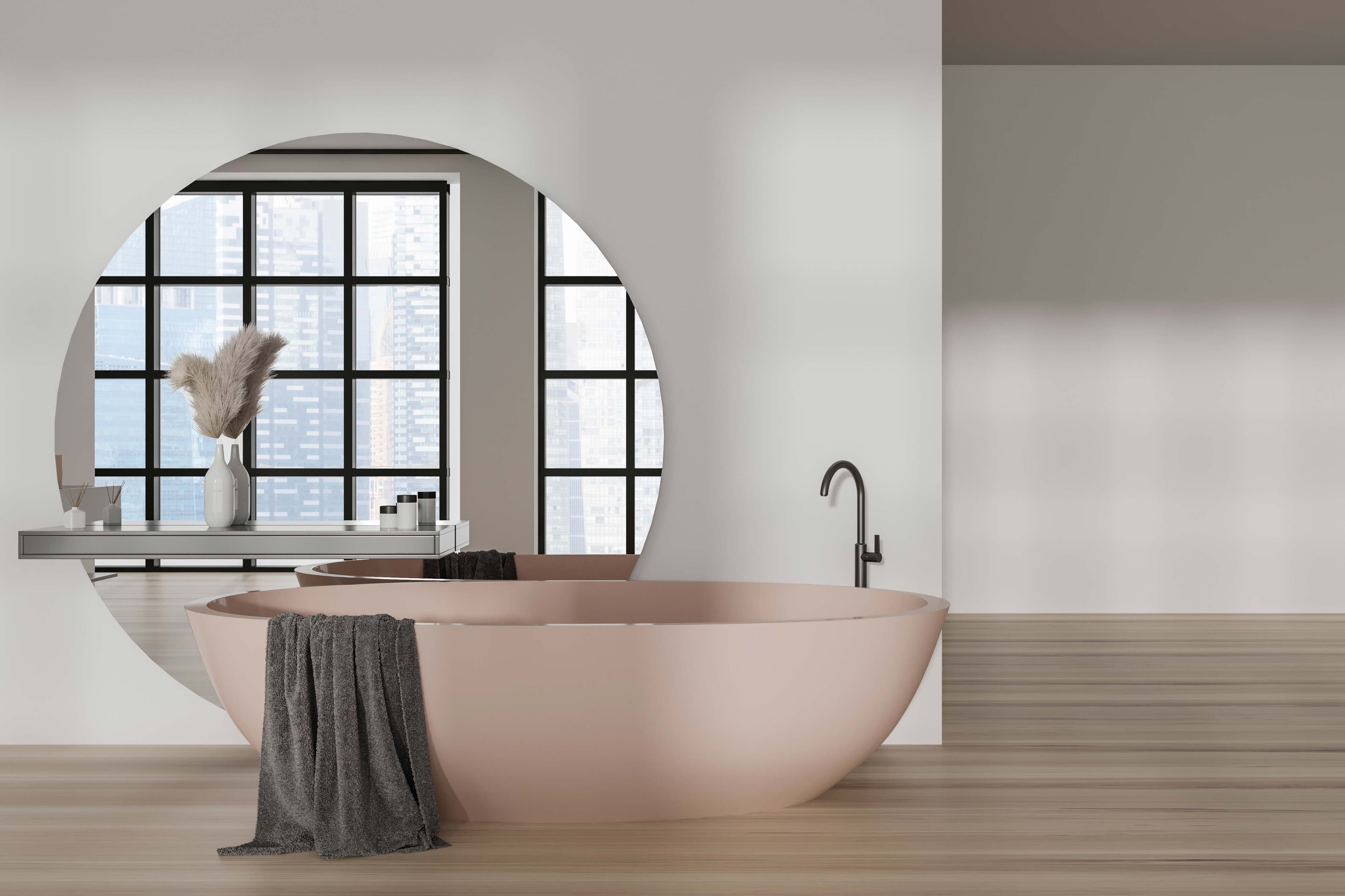Modern bathroom featuring a circular mirror, freestanding bathtub, and sleek countertop, highlighting custom glass, mirrors, and tempered glass design elements.