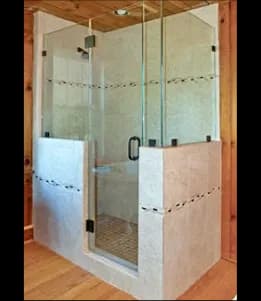 Custom glass shower doors with tempered glass and beveled glass edges in a modern bathroom setting.