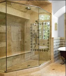 Custom shower doors featuring tempered glass in a beautifully designed bathroom with elegant tile work and natural lighting.