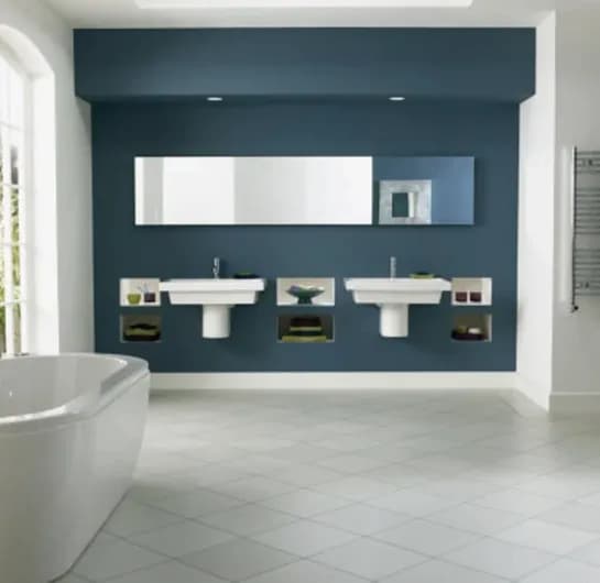 Modern bathroom featuring a large wall mirror above stylish sinks