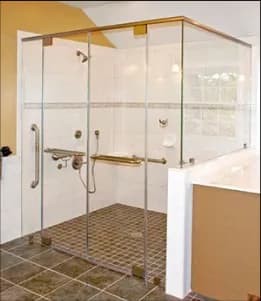 Custom glass shower doors featuring a sleek, modern design with tempered glass and beveled glass edges, complementing a contemporary bathroom layout.