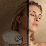 Woman enjoying a shower behind a sleek tempered glass shower door