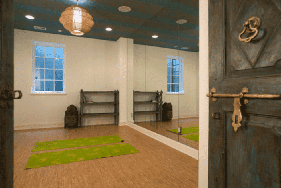 Interior view of a serene yoga room featuring a large mirror wall