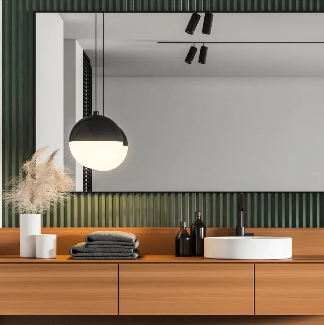 Modern bathroom interior featuring a large custom mirror above a wooden vanity, complemented by stylish decor, perfect for showcasing custom glass solutions, including shower doors and beveled glass edges.