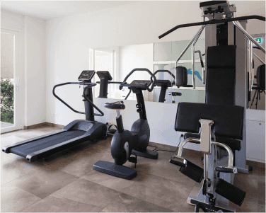 Fitness room with exercise equipment and wall mirrors