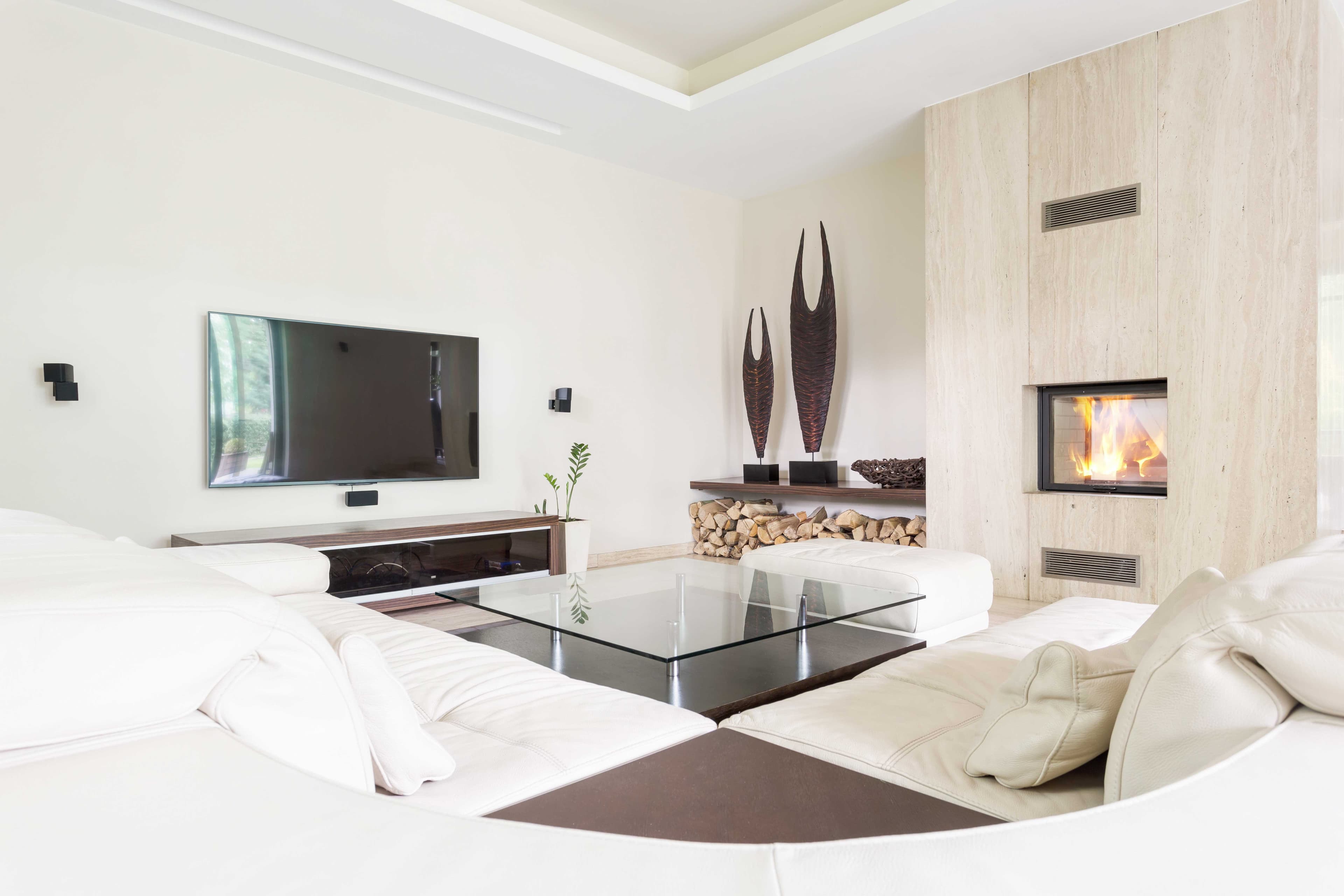 Modern living room featuring a glass coffee table, highlighting custom glass craftsmanship, with a focus on reflective surfaces and elegant design elements suitable for shower doors, table tops, mirrors, and tempered or beveled glass edges.