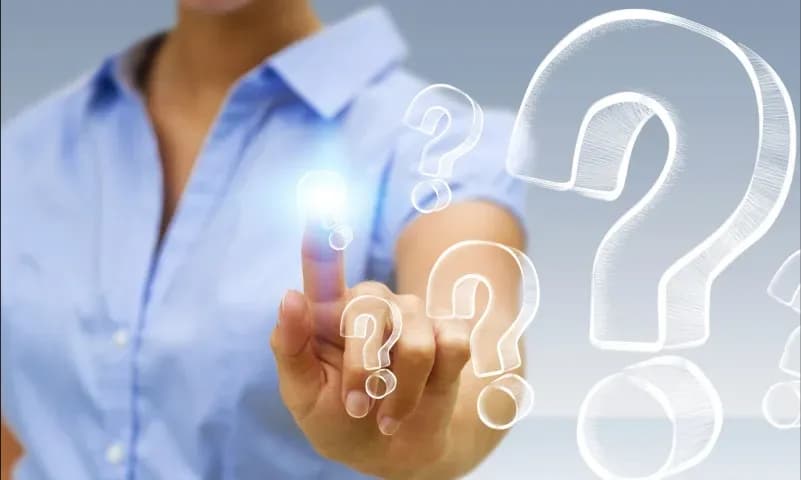 Person interacting with floating question marks, symbolizing inquiries about custom glass solutions like shower doors, table tops, mirrors, tempered glass, and beveled glass edges.