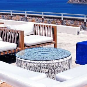 Stylish outdoor seating area featuring a custom glass table top with a unique design