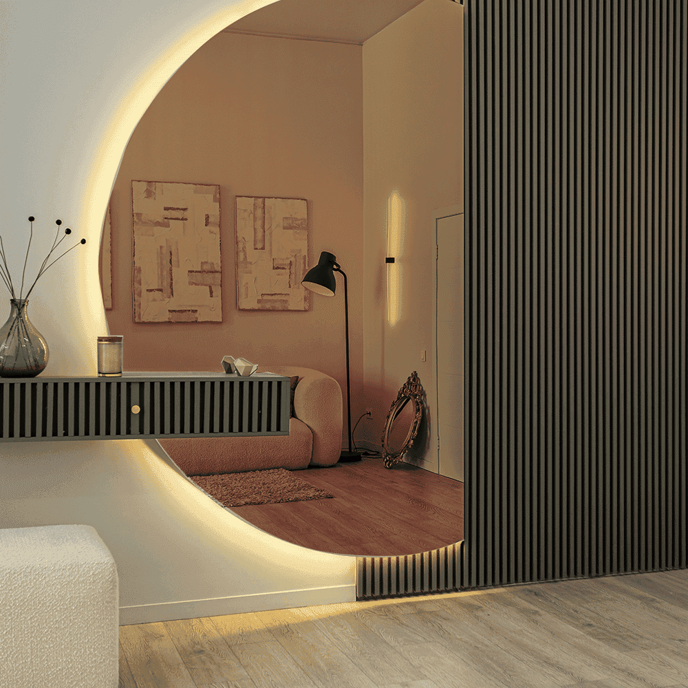 Modern interior featuring a stylish custom beveled glass mirror reflecting a cozy living space, complemented by elegant decor and contemporary furniture, highlighting the versatility of custom glass applications.