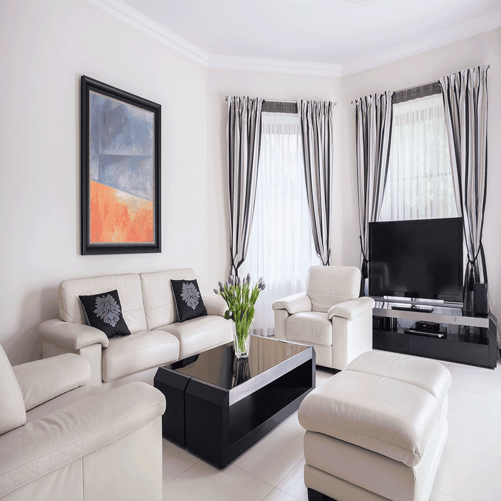 Modern living room with custom glass table top, showcasing sleek design, surrounded by contemporary furniture and decor, highlighting the elegance of glass features.