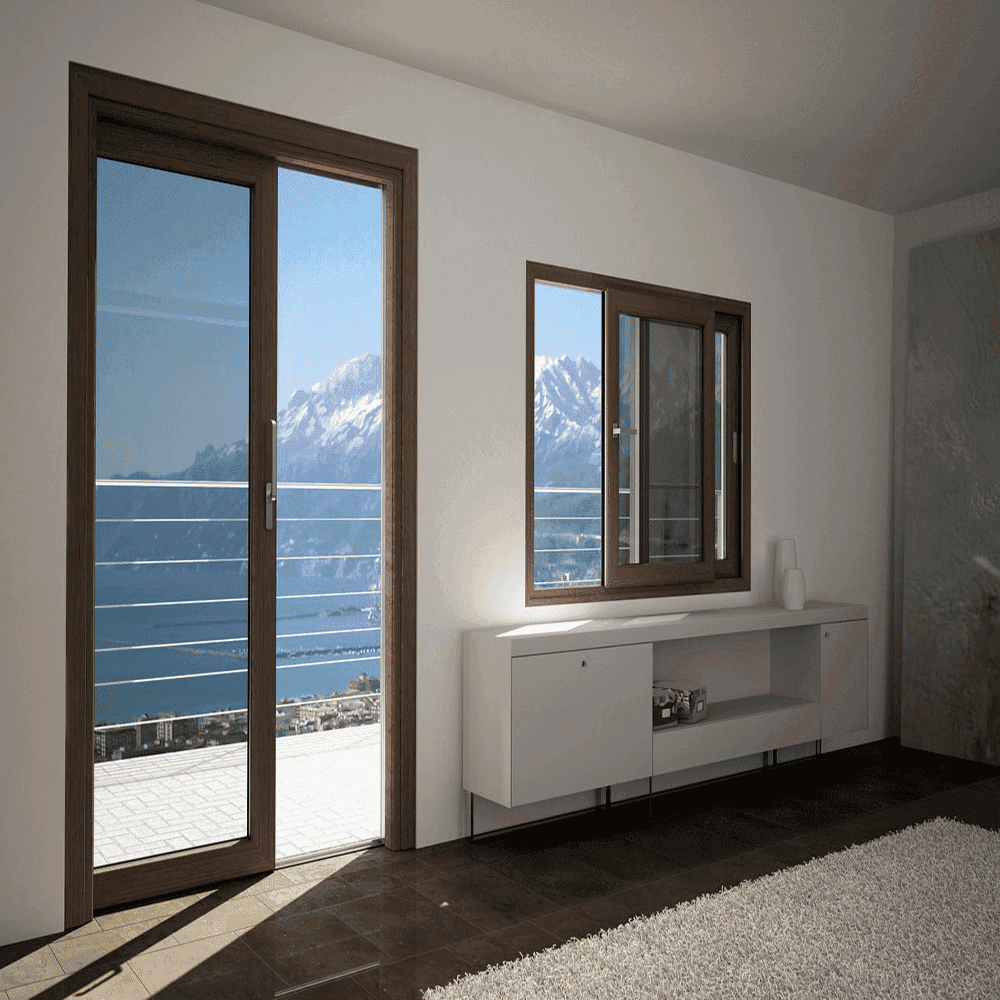 Modern interior featuring large glass sliding doors and windows, showcasing stunning mountain views; ideal for custom glass solutions including shower doors, tempered glass, and beveled glass edges.