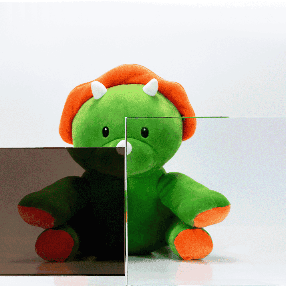 Plush dinosaur toy behind custom glass panels, showcasing options for shower doors, table tops, and beveled glass edge.