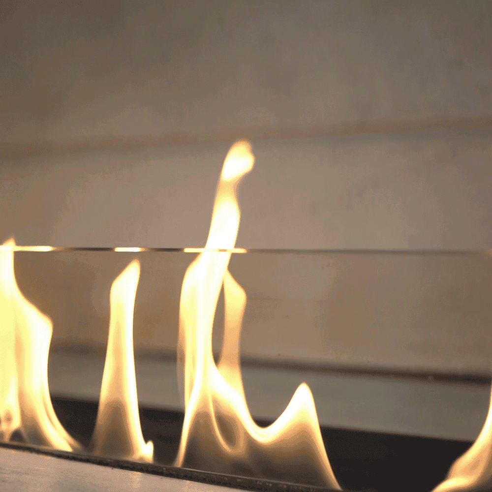 Custom glass featuring a clear panel with flames, showcasing the durability of tempered glass for shower doors, table tops, and mirrors with a beveled glass edge.