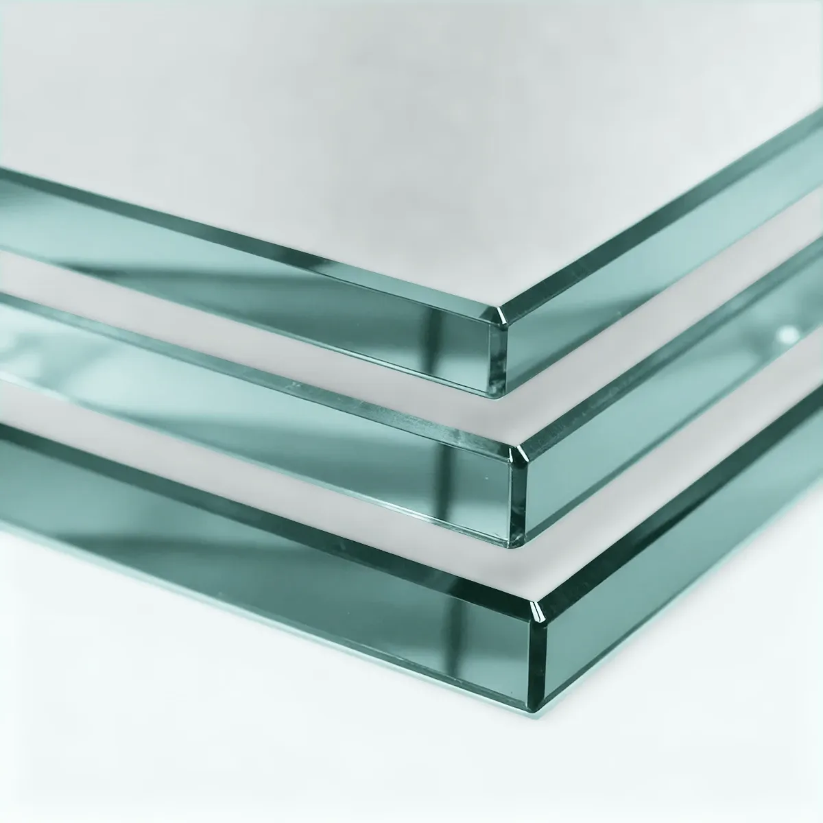 A close-up of three stacked panels of thick, acid-etched frosted glass, highlighting their matte surface and polished, green-tinted edges.