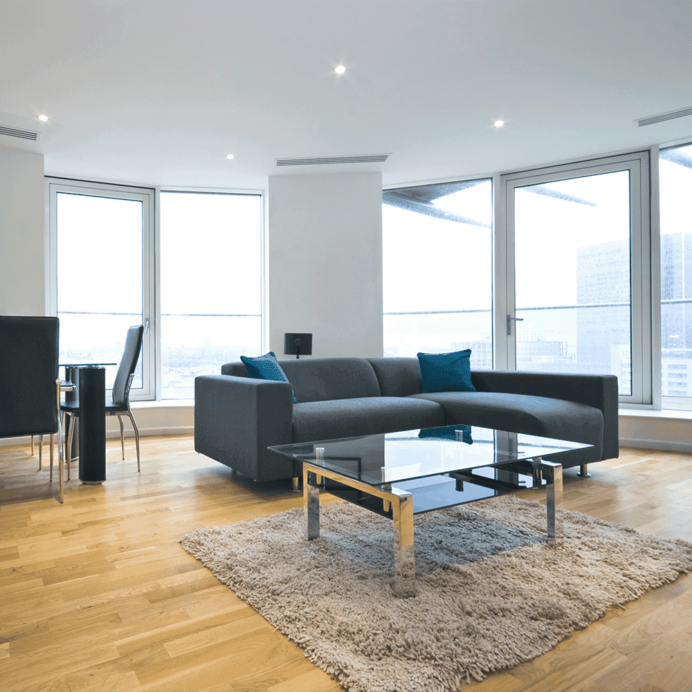 Modern living room featuring a sleek glass table top