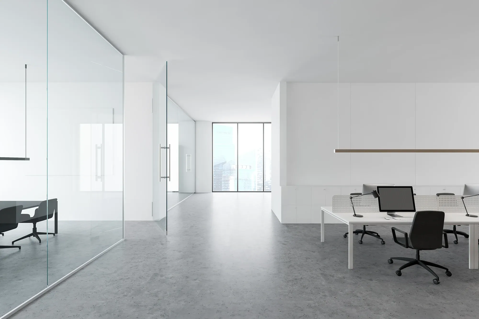 The interior of a bright, modern office featuring a glass-walled meeting room, an open-plan workspace with white desks, and polished concrete floors.