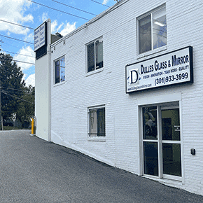 Dulles Glass & Mirror storefront showcasing custom glass solutions including shower doors, table tops, mirrors, tempered glass, and beveled glass edges.