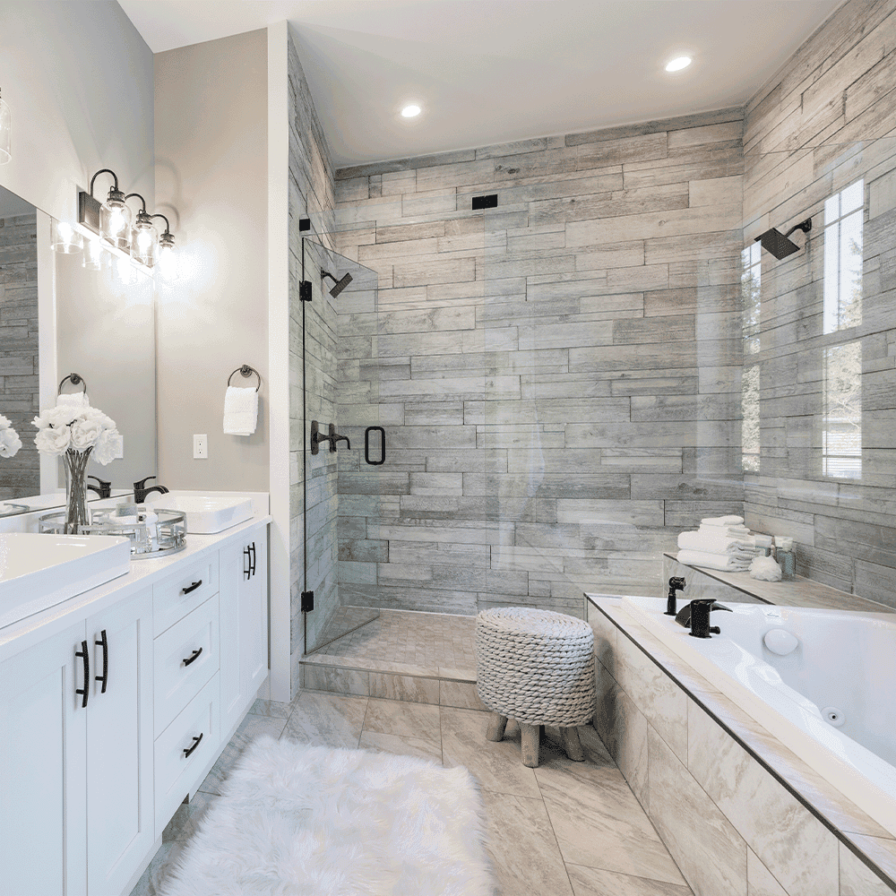 Modern bathroom featuring a glass shower door, custom mirrors, and elegant fixtures, showcasing tempered glass finishes and a stylish design.