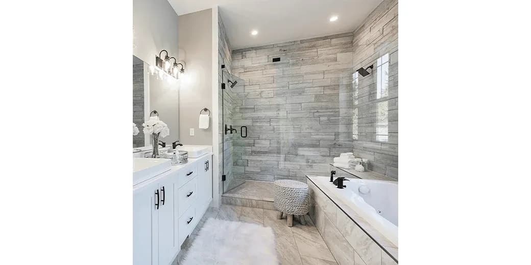 Modern bathroom featuring a glass shower door, custom mirrors, and elegant fixtures, showcasing tempered glass finishes and a stylish design.