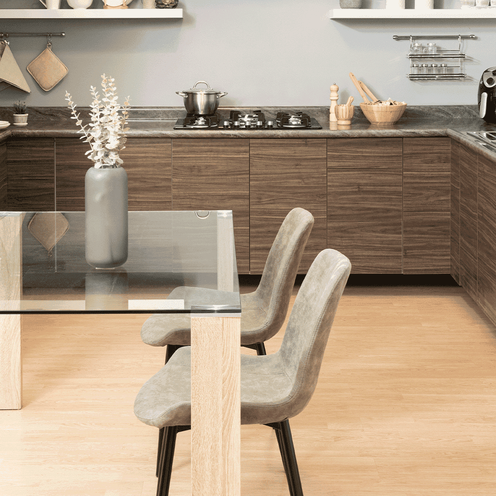 Modern kitchen featuring a custom glass table top with beveled glass edges, paired with stylish chairs and a minimalist design.