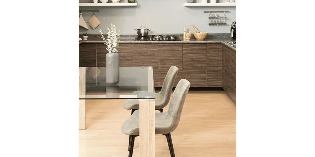 Modern kitchen featuring a custom glass table top with beveled glass edges, paired with stylish chairs and a minimalist design.
