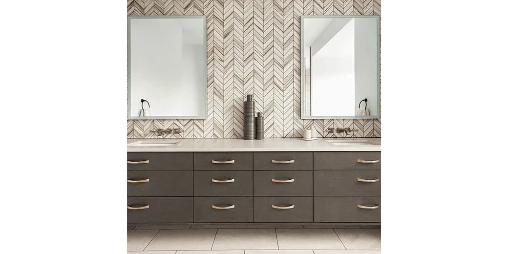 Modern bathroom with two large mirrors, sleek cabinetry, and a stylish herringbone wall design, featuring custom glass elements, ideal for showcasing shower doors, tempered glass, and beveled glass edge options.