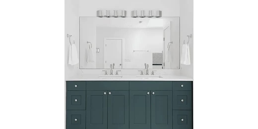 Bathroom featuring a sleek custom mirror above a dual sink vanity with a modern design, showcasing tempered glass fixtures and elegant cabinetry.