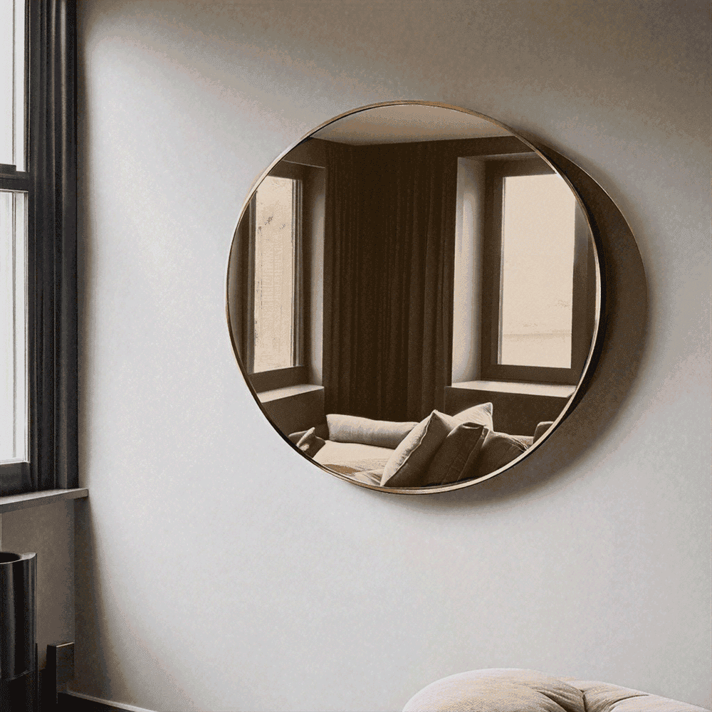 Round mirror reflecting a cozy interior, showcasing custom glass design with beveled edge, ideal for modern home decor alongside shower doors and table tops.